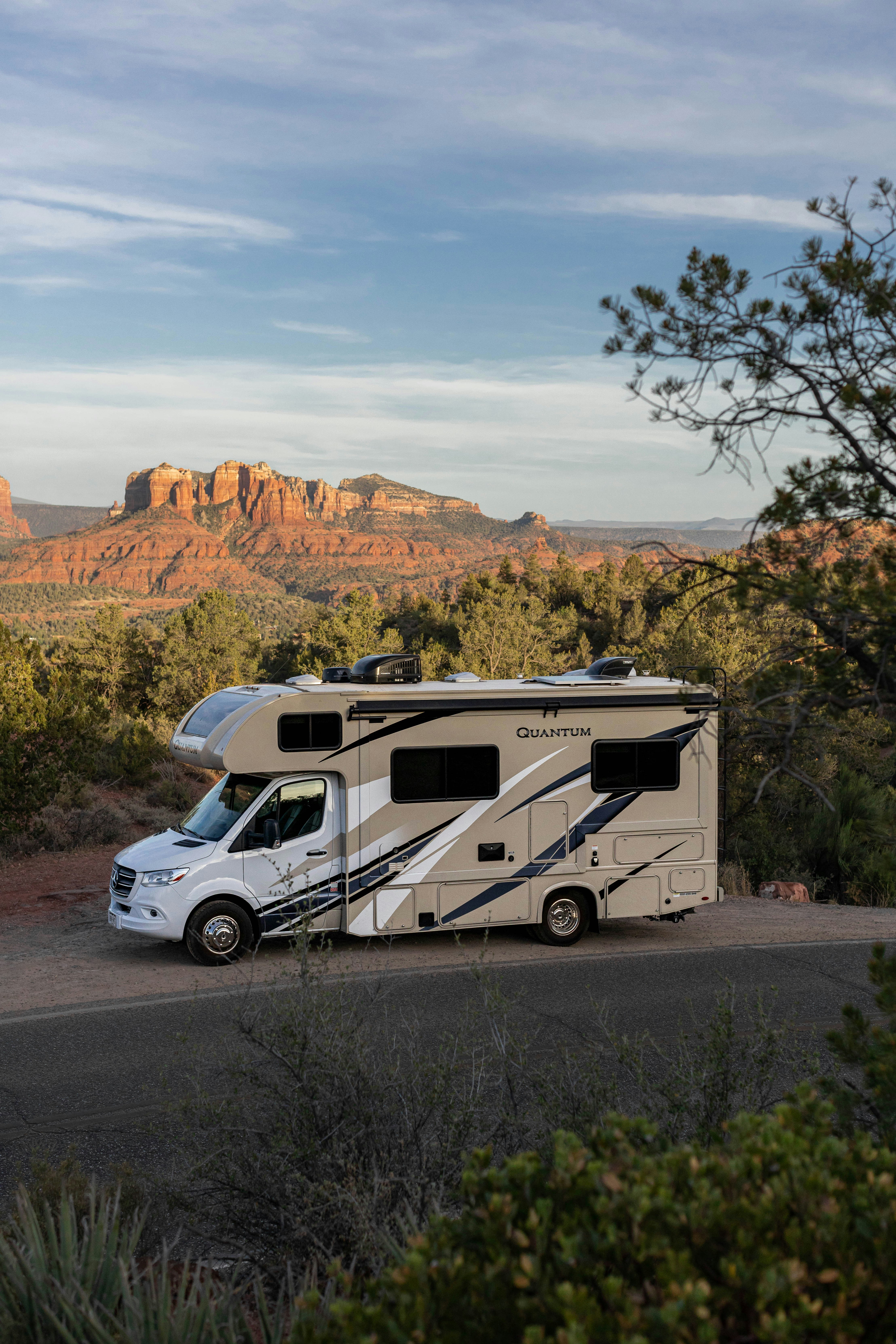 RV on a desert road with mountains