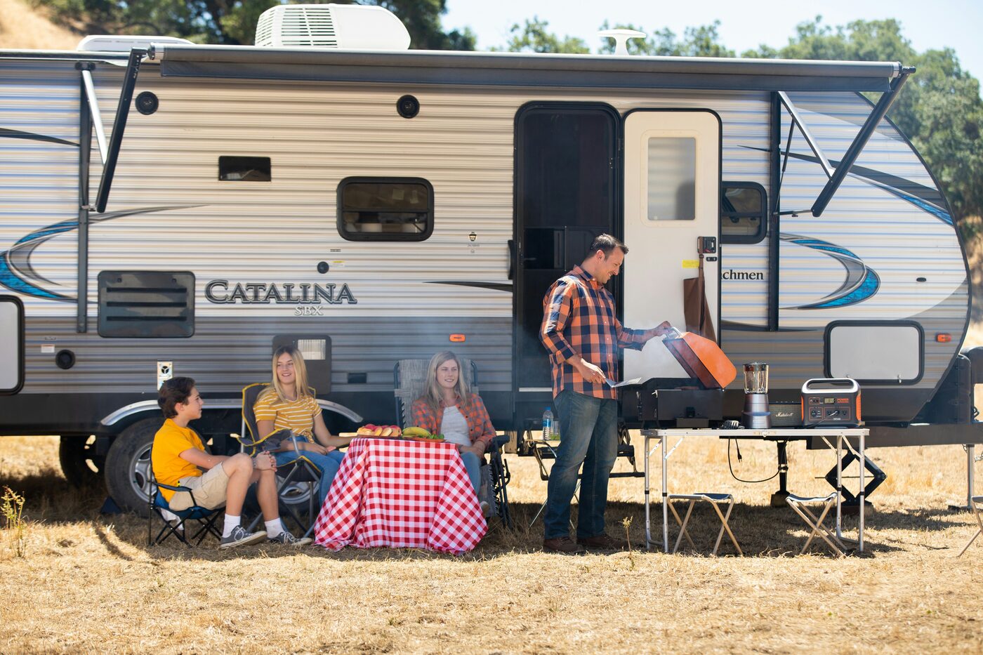Family barbecue beside their motorhome